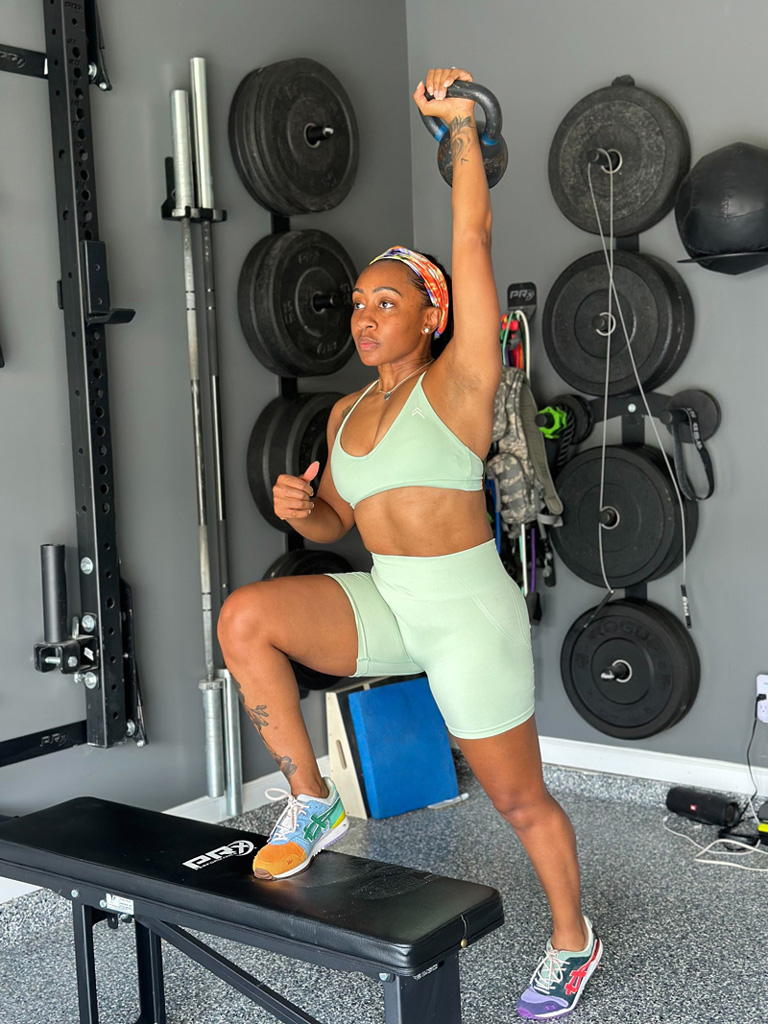 picture of the coach lifting weight over the head